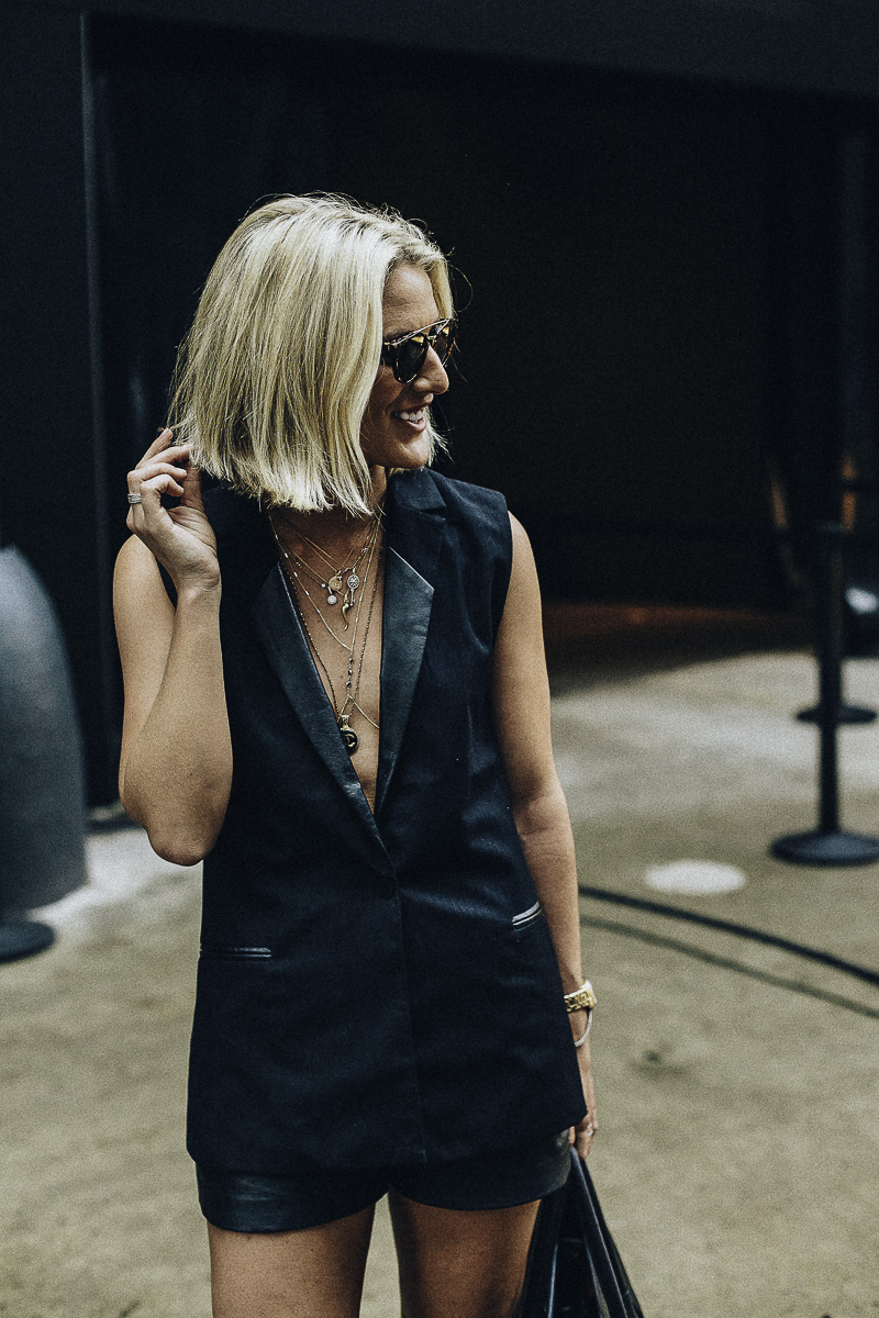 low cut vest and layered necklaces