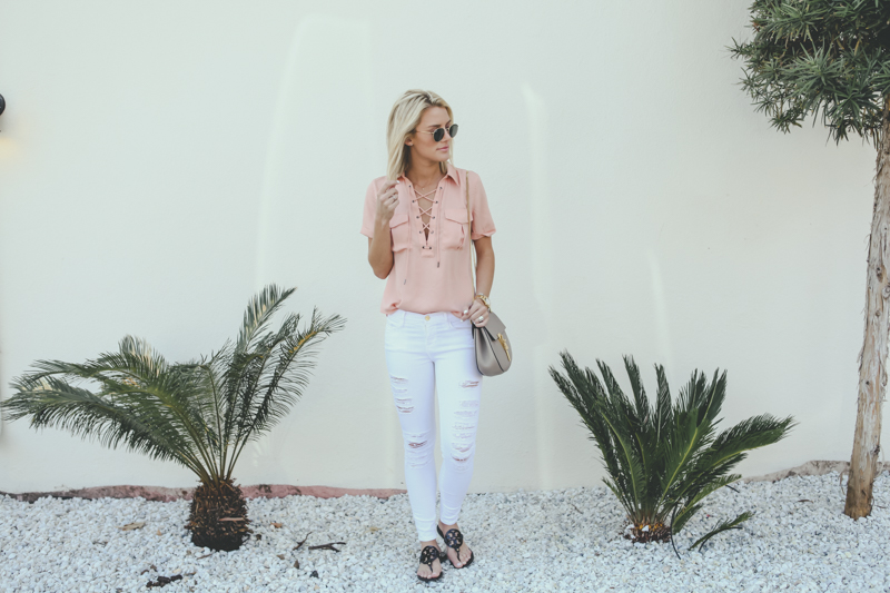 pink lace up top and white jeans