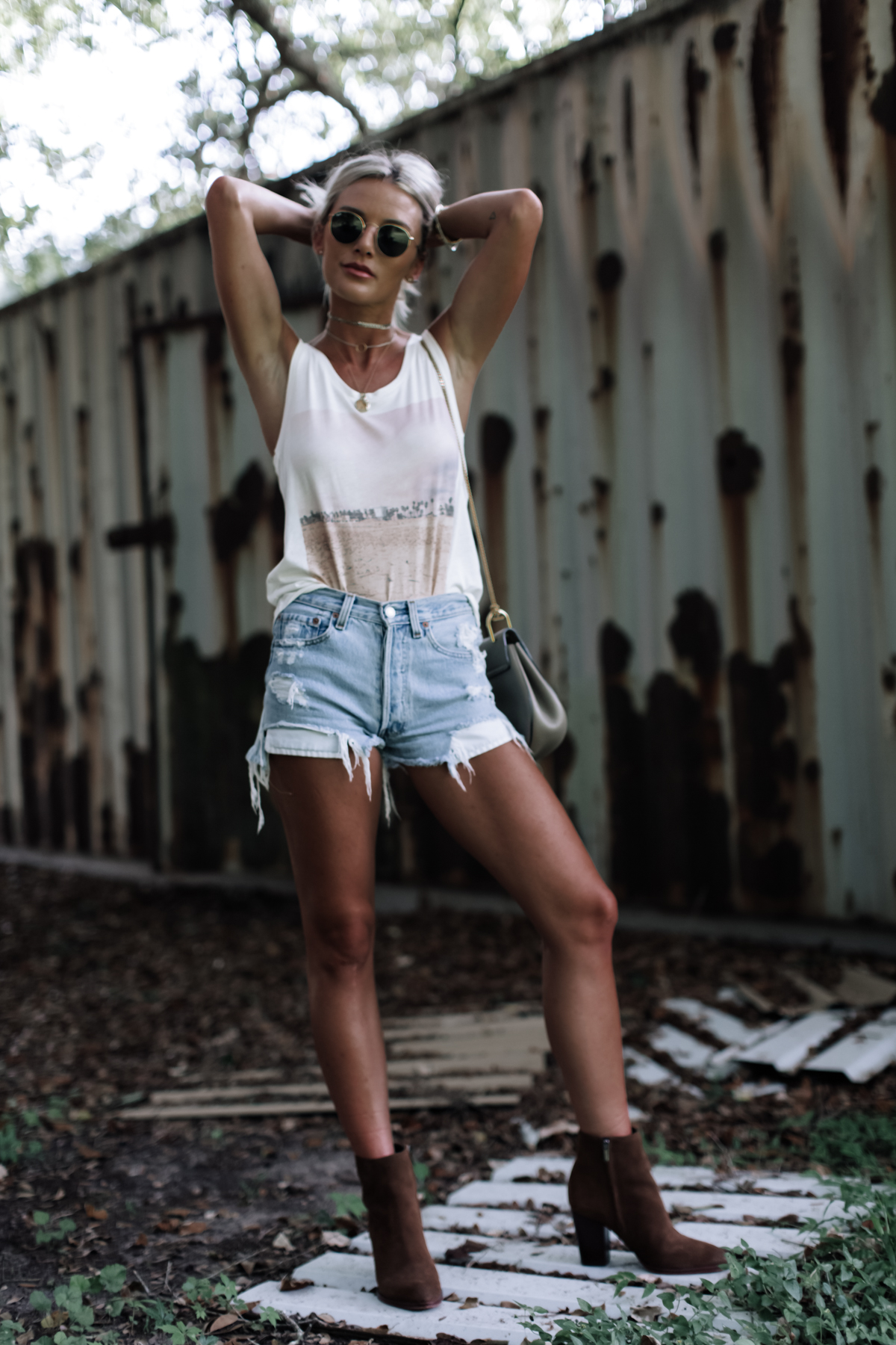 graphic tank and denim shorts festival outfit on blogger So Sage