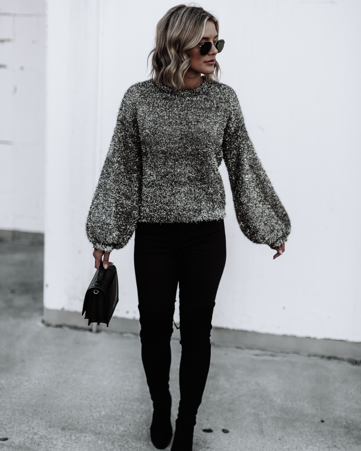 blogger So Sage wearing a fluffy sweater and jeans with OTK boots