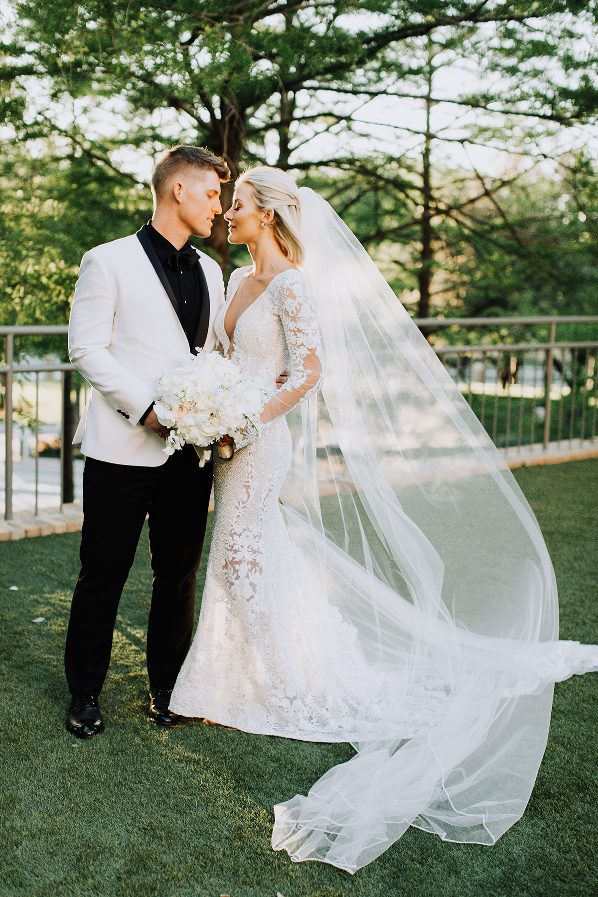 long sleeve wedding dress with low back and long veil from bridal boutique