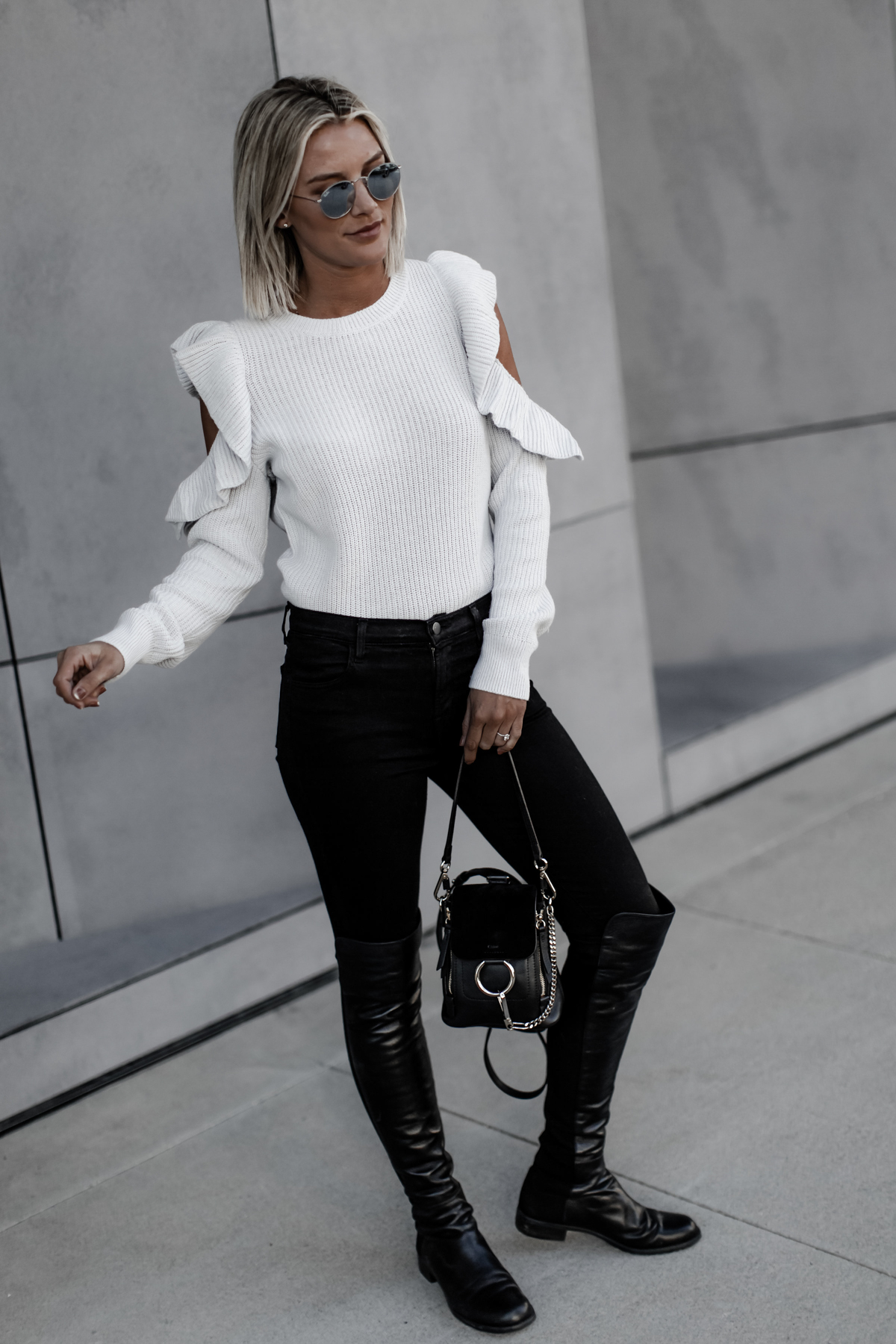 cute grey cold shoulder sweater and black jeans outfit on Sage Coralli of So Sage