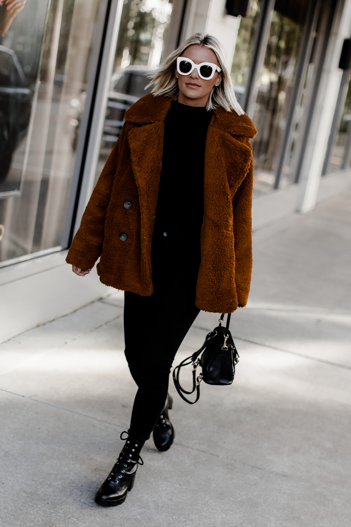 Blogger So Sage in a rust color oversized cozy coat