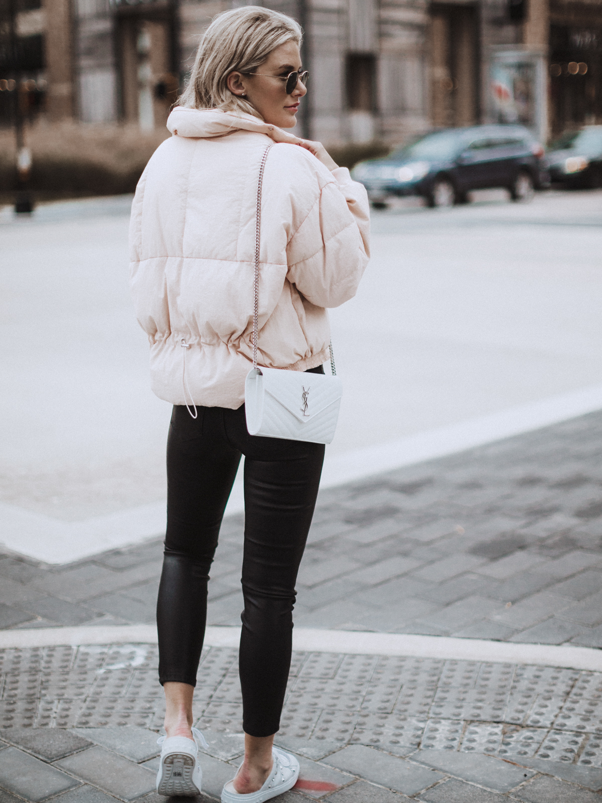 Sage Coralli in a pink puffer jacket and leather pants outfit