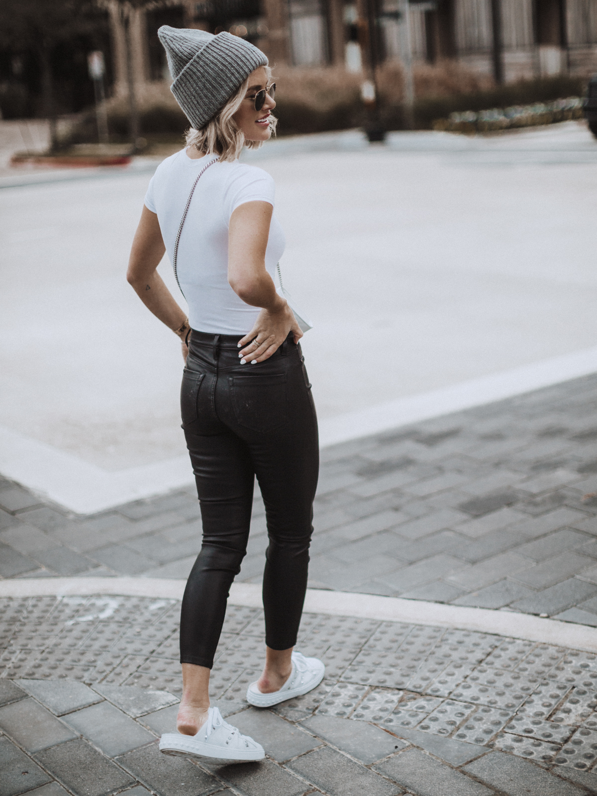 leather pants paired with slide sneakers on blogger So Sage