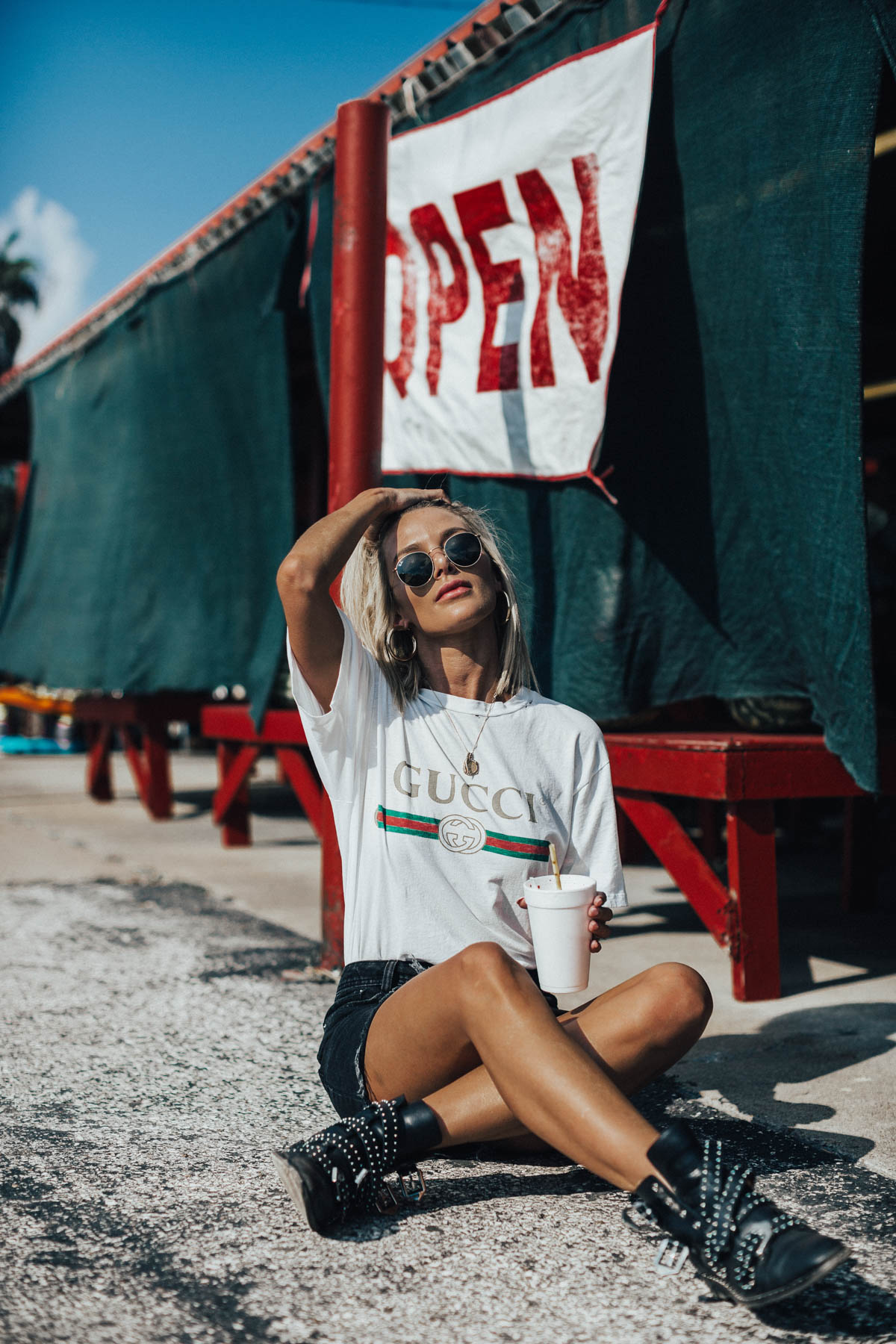blogger Sage Coralli styling a 90's inspired look wearing the Gucci logo tee