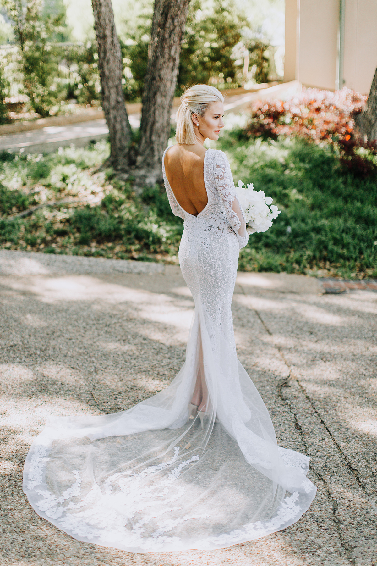 long sleeve wedding dress with low back and tulle train on Sage Coralli of So Sage Blog